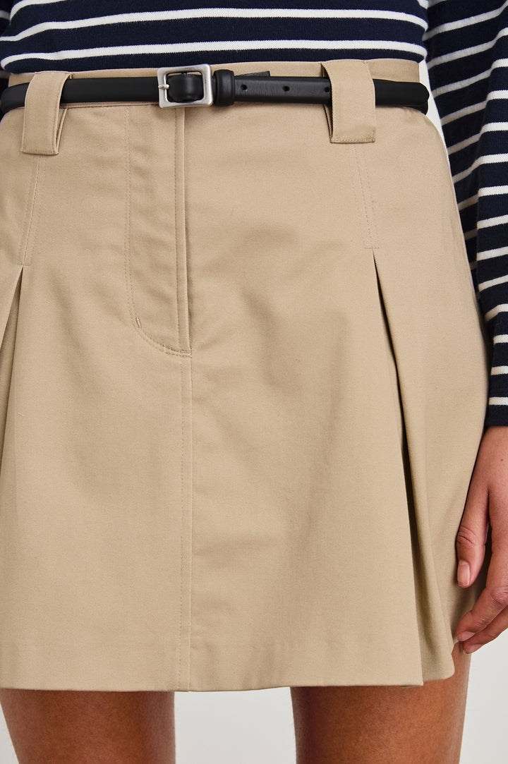 Alfie high waisted mini skirt with pleats in Taupe - close up of details on model