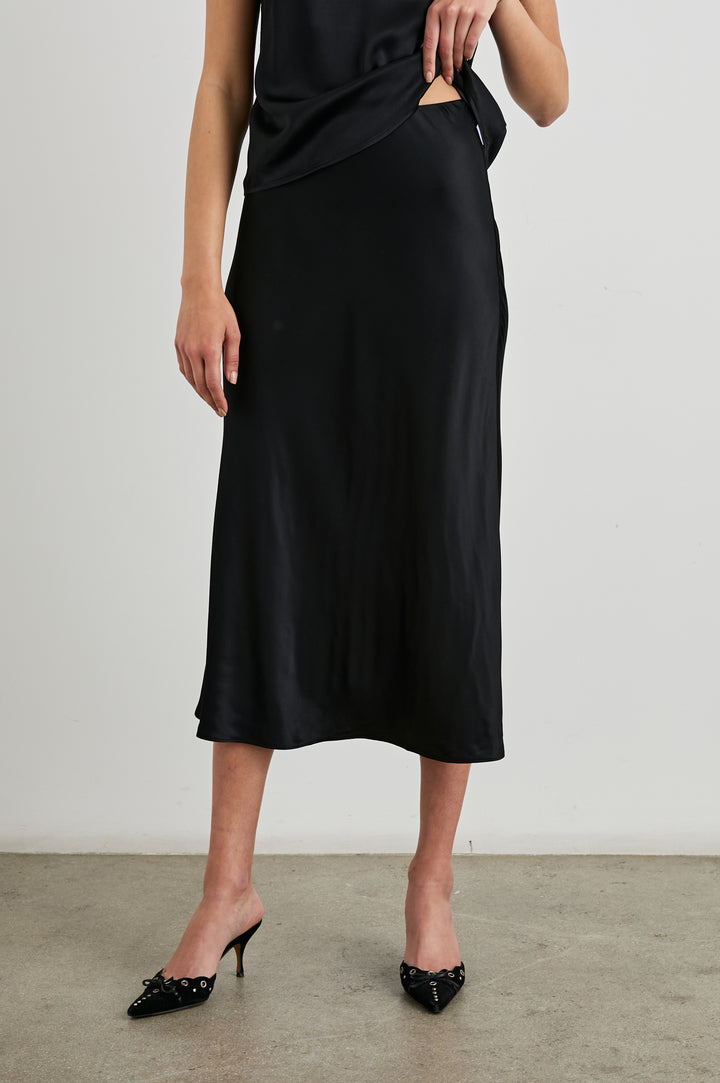 Anya High-waisted Midi Skirt in Black Colorway - Front View Featured on Model