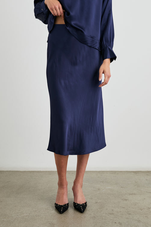 Anya High-waisted Midi Skirt in Navy Colorway - Front View Featured on Model