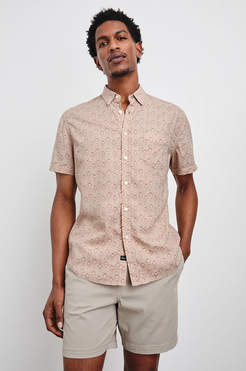 Carson linen short sleeve button down with a collar and ornamental pattern in Batik Flamingo - front view on model, hand in pocket