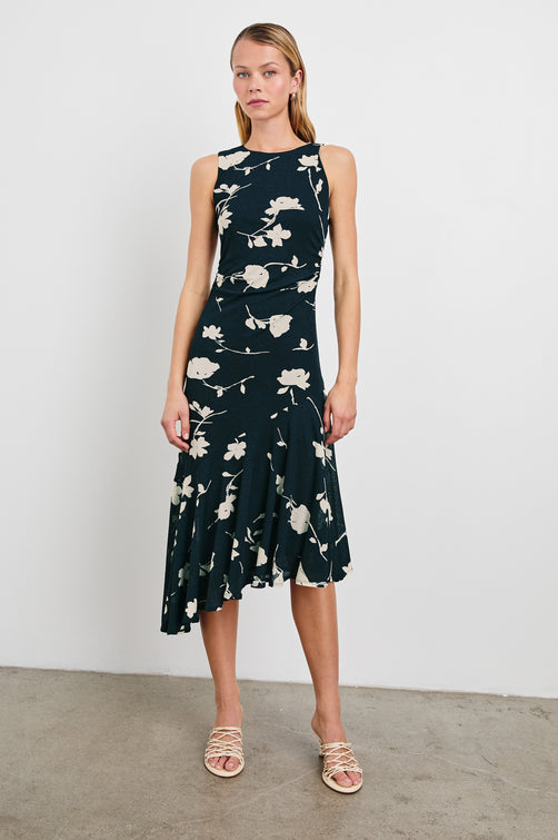 Daija Sleeveless Midi Dress with a Pleated Asymmetrical Hemline, and a Crew Neckline in Midnight Roses Colorway, with cream roses on Midnight - Front Full Body View Featured on Model