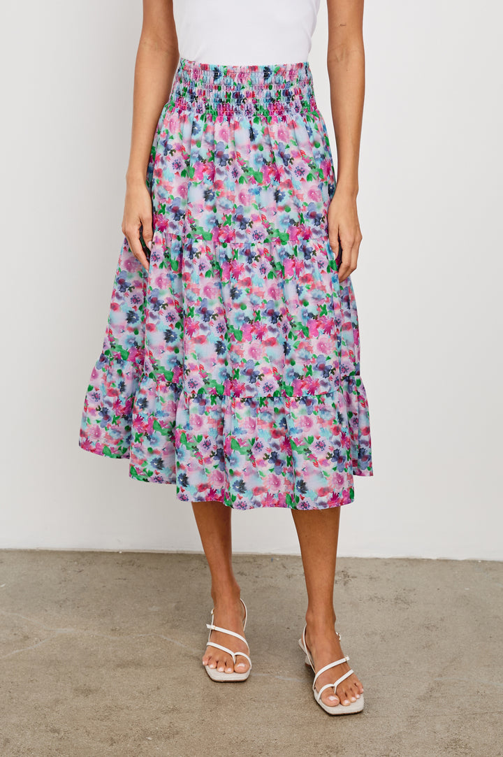 Edina Tiered Midi Skirt with Shirred High-Rise Waistline in Spring Floral Colorway, with mostly pinks and purples - Front View Featured on Model