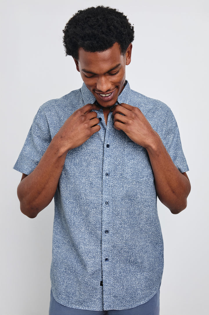 Fairfax short sleeve button up shirt with collar in Abstract Block Blue - front view on model, hands on collar