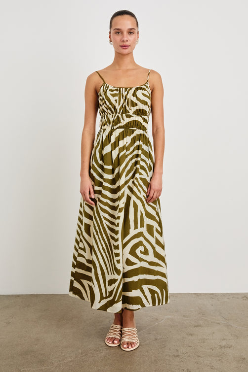 Fatima full length dress with hand painted abstract design, smocked waist, and spaghetti straps in Selva - front view on model