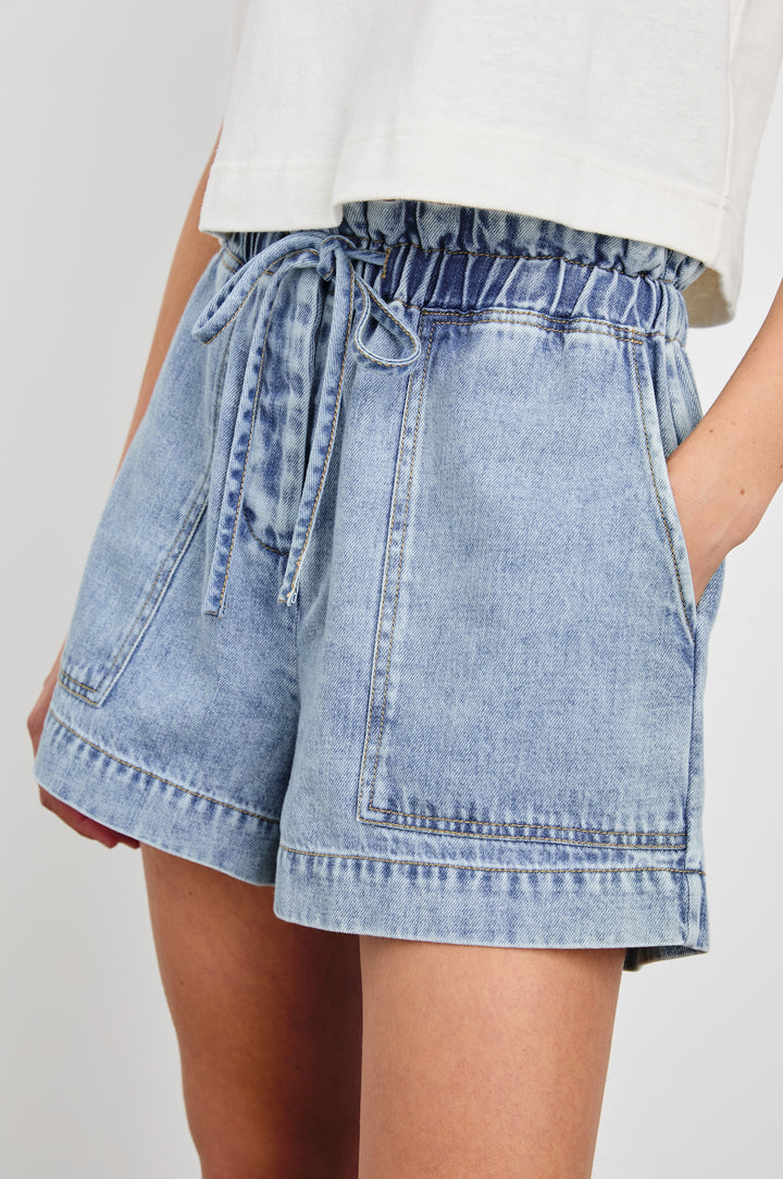 Foster Shorts with Paperbag Drawstring Waist, Large Front Pockets and Decorative Back Pockets in Faded Indigo Colorway - Front View Featured on Model