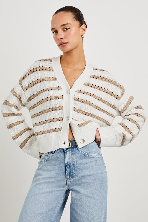 Geneva cropped cardigan sweater with front buttons and contrast trimmings in Ivory Oat Stripe - front view on model with hands on hips