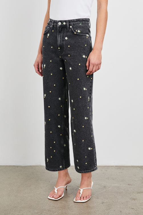 Getty Crop Wide Leg Denim Pants with Belt Loops, Two Front Pockets and Two Back Patch Pockets in Ash Black Floral Colorway, with yellow and purple flowers on Ash - Front View Featured on Model