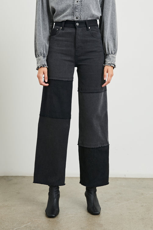 Getty Crop Wide Leg Denim Pants with Belt Loops, Two Front Pockets and Two Back Patch Pockets in Black Patchwork Colorway, with horizontal patches in shades of Black - Front View Featured on Model