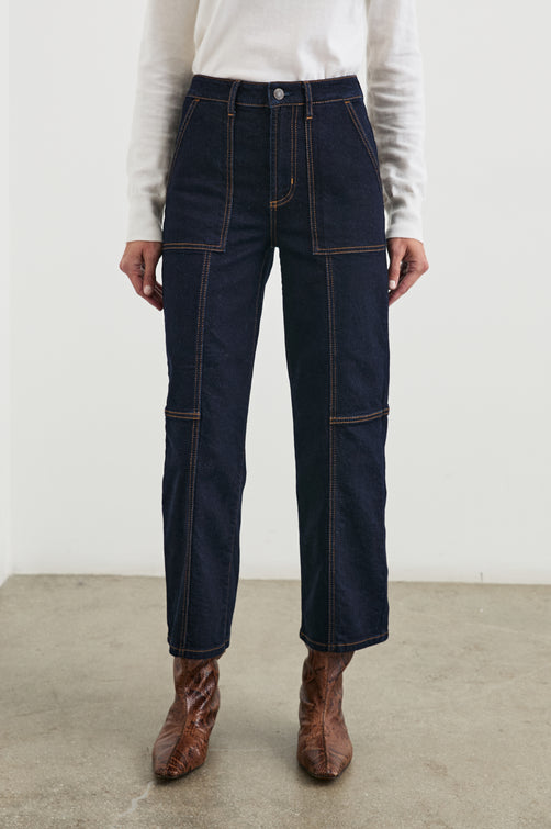 Getty Crop Wide Leg Denim Pants with Belt Loops, Additional Seams, Two large Front Pockets and Two Back Patch Pockets in Midnight Blues Colorway, Gold Tone Stitching along Seams - Front View Featured on Model