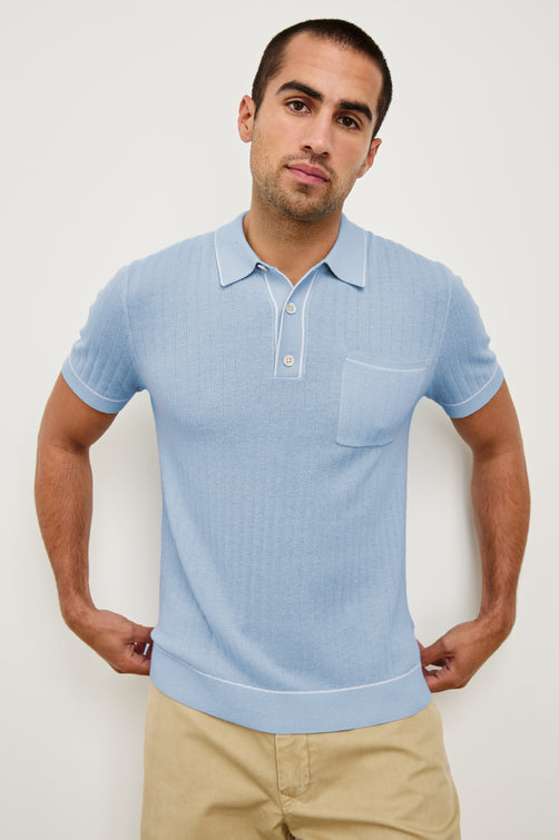 Hardy short sleeve cotton rib polo with chest pocket, two button placket and contrast stitching in Light Blue Melange - front view on model