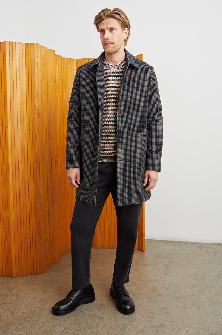 Hockney Mid-Thigh Length Overcoat with Button Closure, Two Front Pockets, and a Back Vent in Grey Check Plaid Colorway, a plaid in Grey, Black and Blue - Front Full Body View Featured on Model