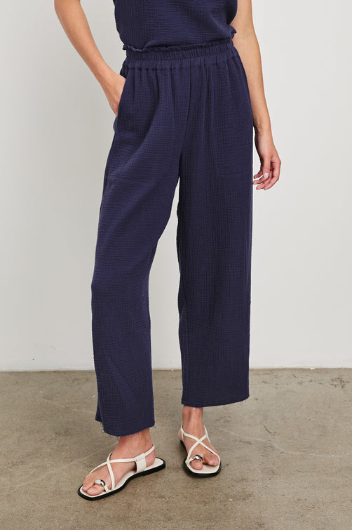 Leon Crop Cotton Gauze Pant With Hemline Slit And Elastic Waist In Colorway Admiral Blue - Front View Featured On Model