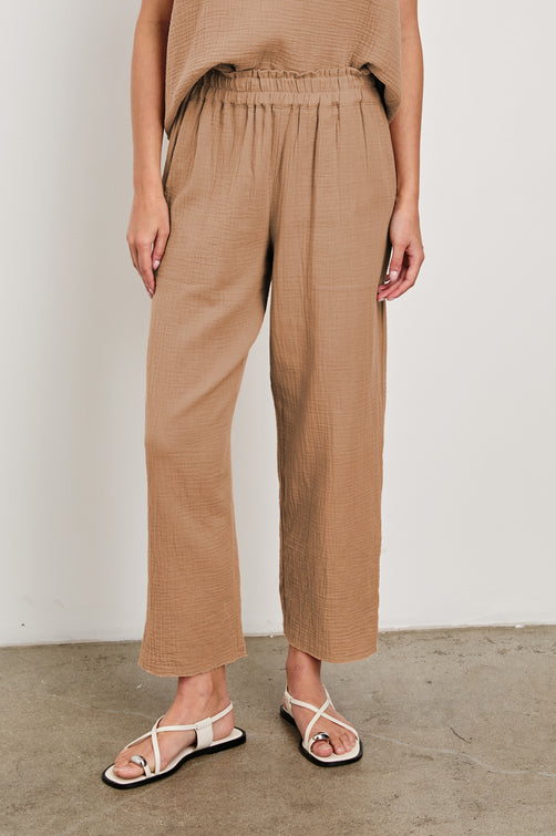 Leon Crop Cotton Gauze Pant With Hemline Slit And Elastic Waist In Colorway Taupe - Front View Featured On Model