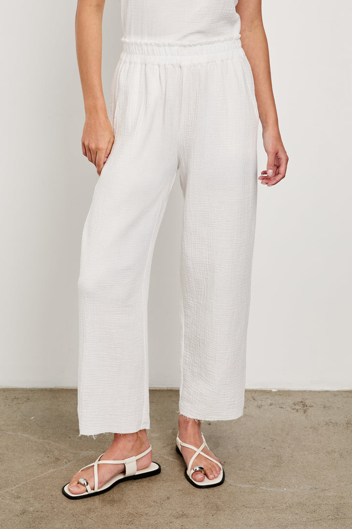 Leon Crop Cotton Gauze Pant With Hemline Slit And Elastic Waist In Colorway White - Front View Featured On Model