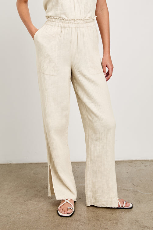 Leon Cotton Gauze Pant With Hemline Slit And Elastic Waist In Colorway Flax - Front View Featured On Model 