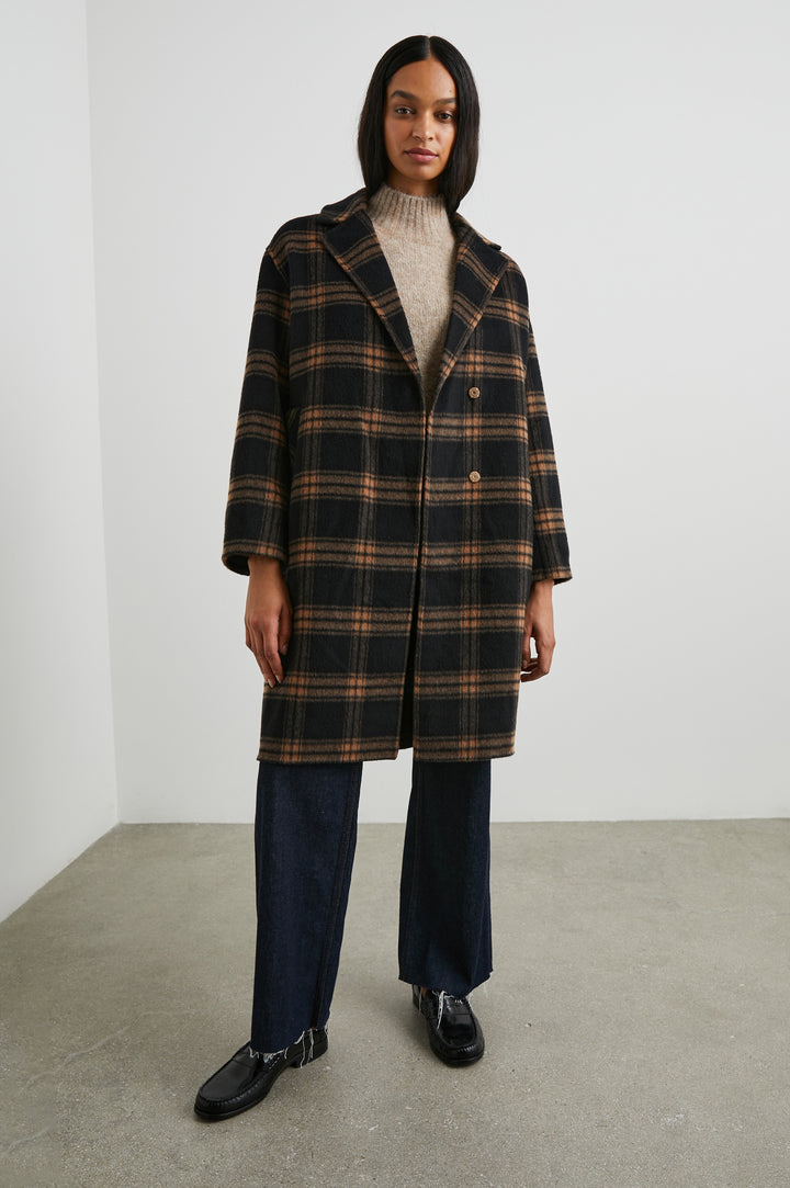 Lore Knee-Length Coat with Two Button Closure, Notched Lapels and Two Front Pockets in Camel Jet Colorway, a Plaid - Front Full Body View Featured on Model