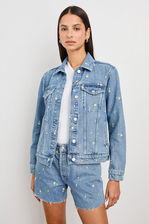 Mulholland Indigo Trucker Style Denim Jacket with 2 Front Pockets, Front Buttons, and Daisy Embroidery Details - Front View on Model, Unbuttoned