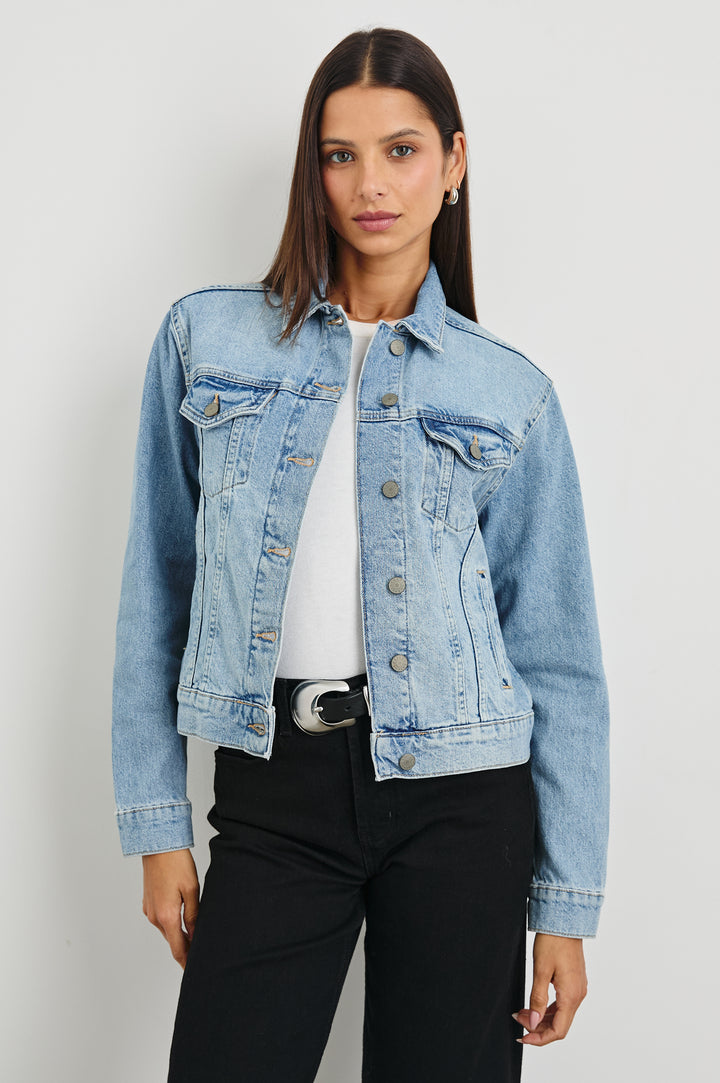 Mulholland Denim Jacket with Button Closure, Two Chest Button Flap Pockets, Two Front Pockets, Adjustable Button Straps on Hem in Original Blue Colorway - Front View Featured on Model  