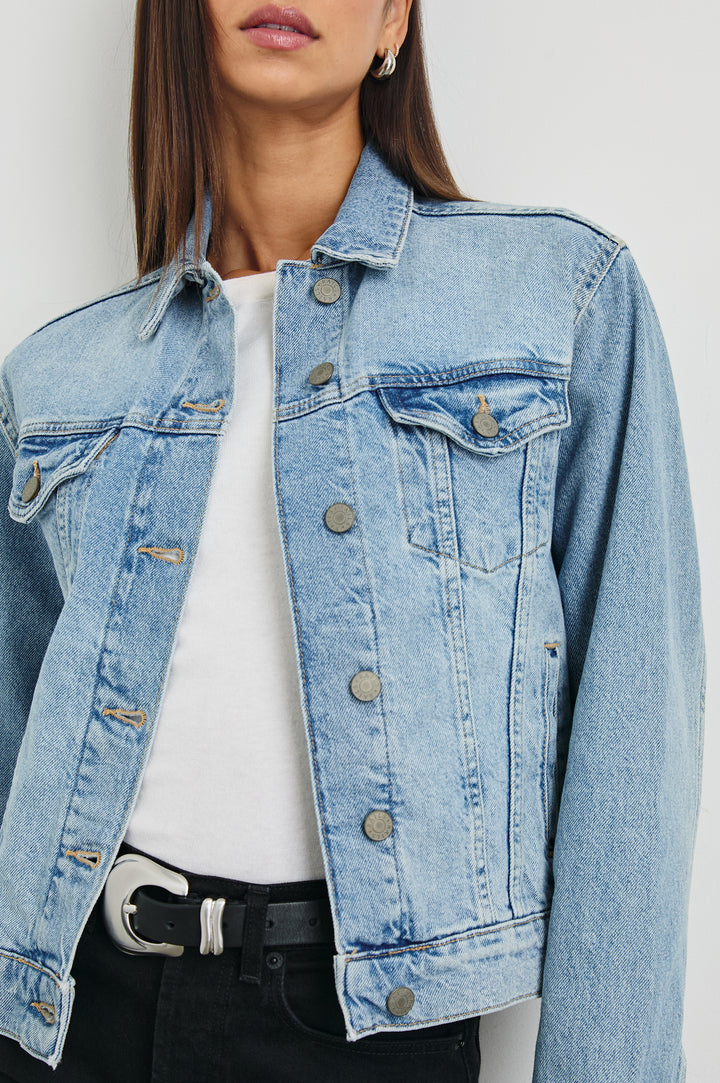 Mulholland Denim Jacket with Button Closure, Two Chest Button Flap Pockets, Two Front Pockets, Adjustable Button Straps on Hem in Original Blue Colorway - Front View Featured on Model  