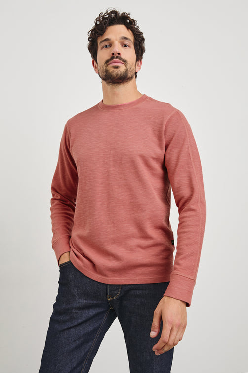 Rheese Long-Sleeve Thermal with Crew Neck and Statement Seams on Sleeves and Back in Red Brick Colorway - Front View Featured on Model