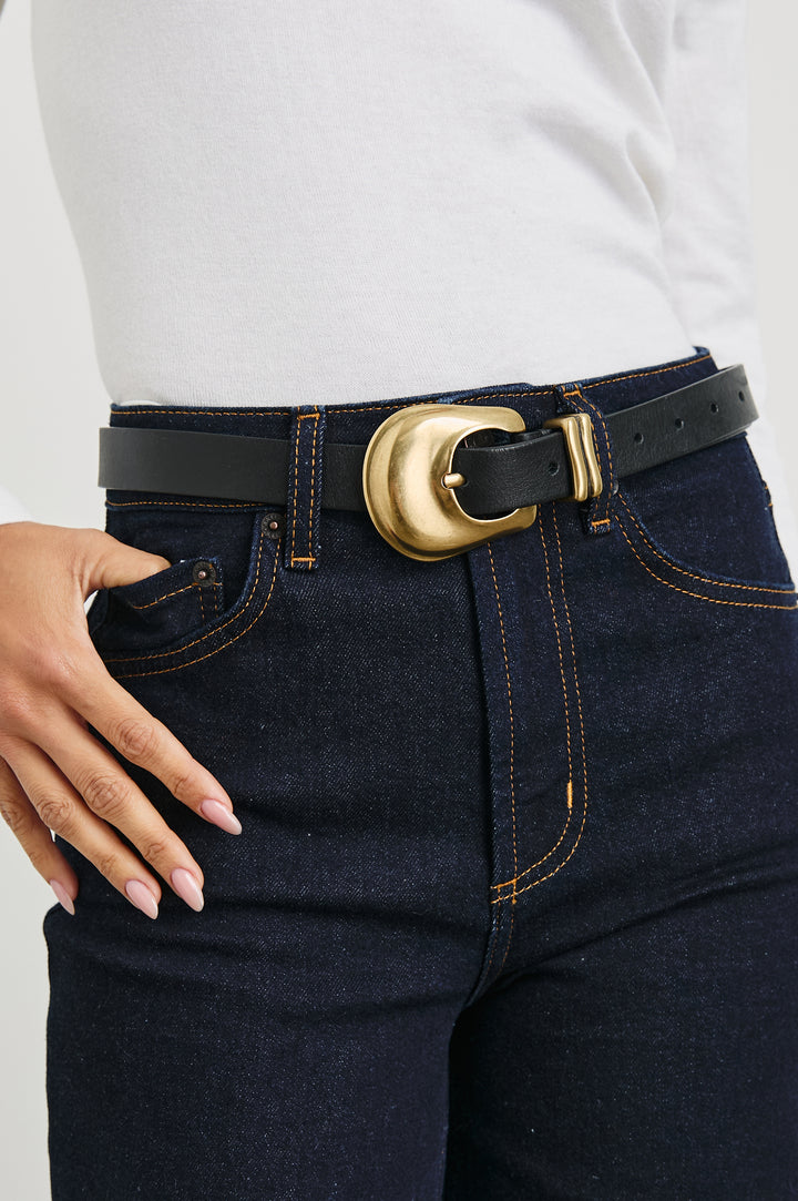 Rodeo Belt with a Black Leather Belt with Belt Loop and a Chunky Gold-Toned Buckle in Brown Gold Colorway - Front View Featured on Model 