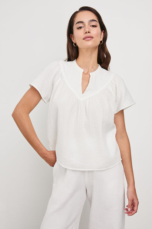 Sayer double cotton gauze flared short sleeve tee with V neckline in White - front view on model with hand on hip