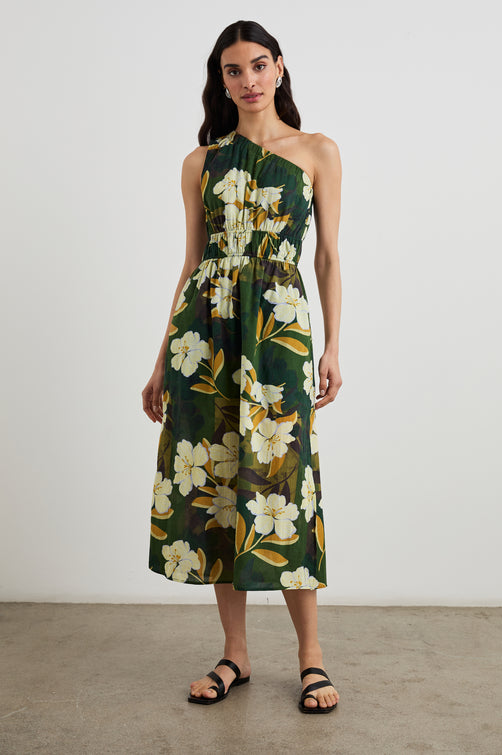 Selani Midi Dress With an Asymmetrical Neckline, Mid-Thigh Slide Slit and Cinched Waistband in Plumerias Colorway, with Ivory and Gold Plumerias on Dark Green  - Front Full Body View Featured on Model