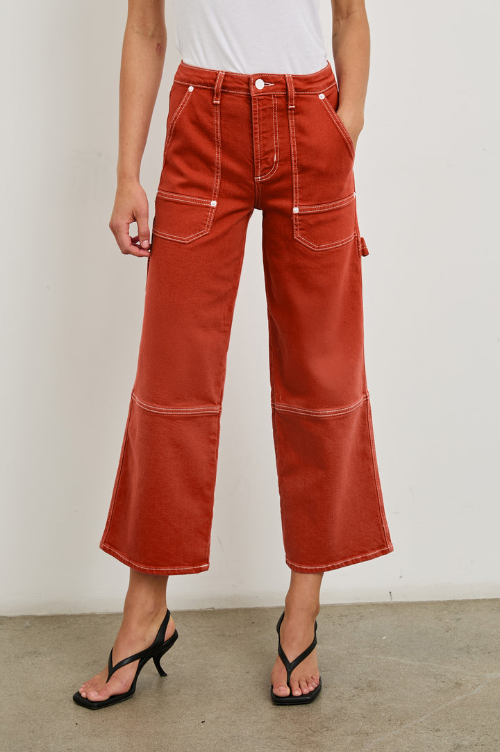 Silverado high rise wide leg crop pant with carpenter style details and contrast stitching in Terracotta - front view on model