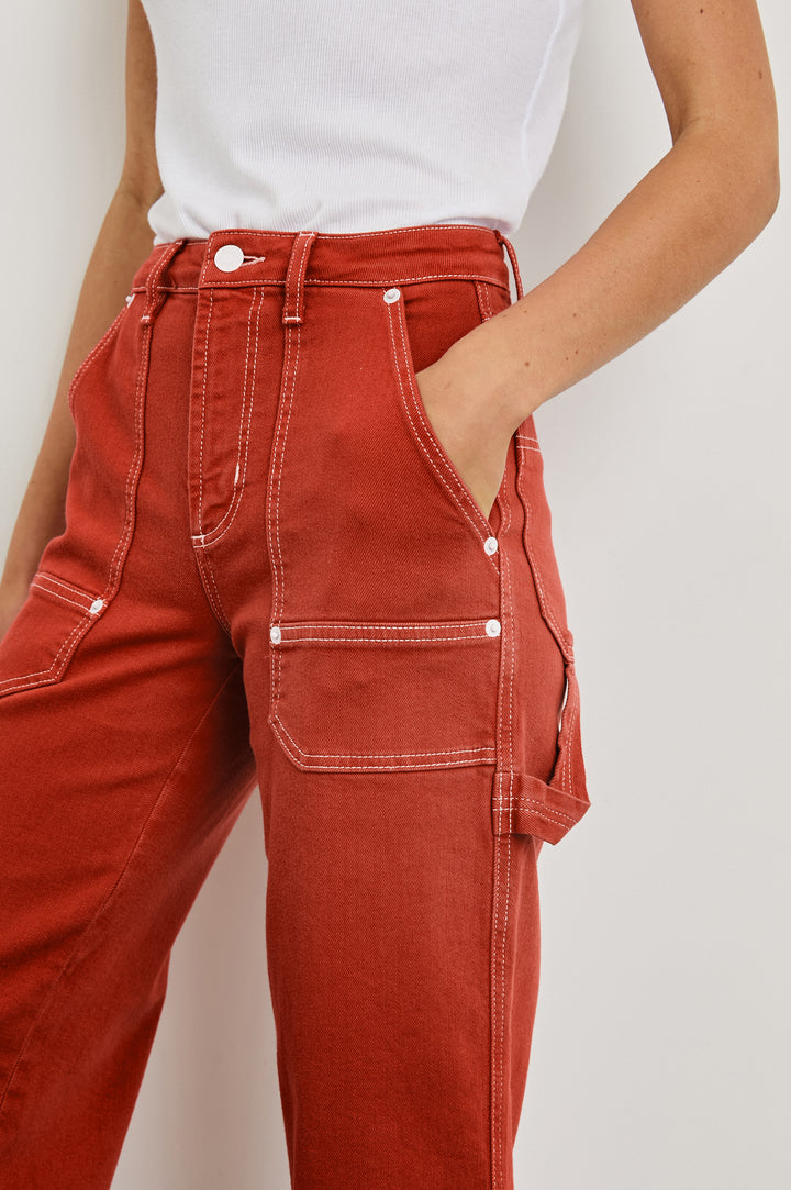 Silverado high rise wide leg crop pant with carpenter style details and contrast stitching in Terracotta - close up of details on model