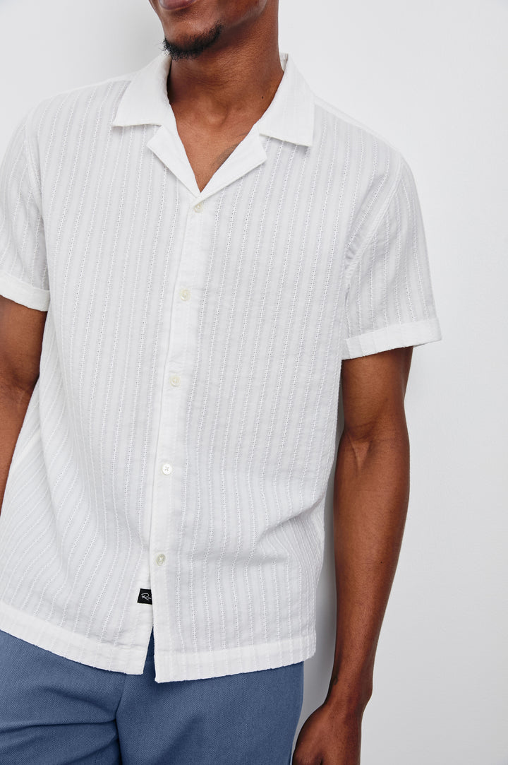 Sinclair lightweight button up short sleeve shirt with subtle stripe texture in White - close up of details on model