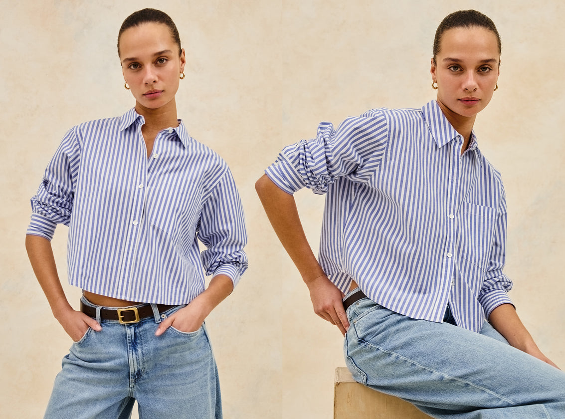 FEMALE MODEL WEARING RAMY SHIRT (LONG SLEEVE, BOXY FIT, AND CROPPED BUTTON DOWN SHIRT WITH COLLAR) IN COLOR MARINER WHITE STRIPE (BLUE AND WHITE VERTICAL STRIPES)